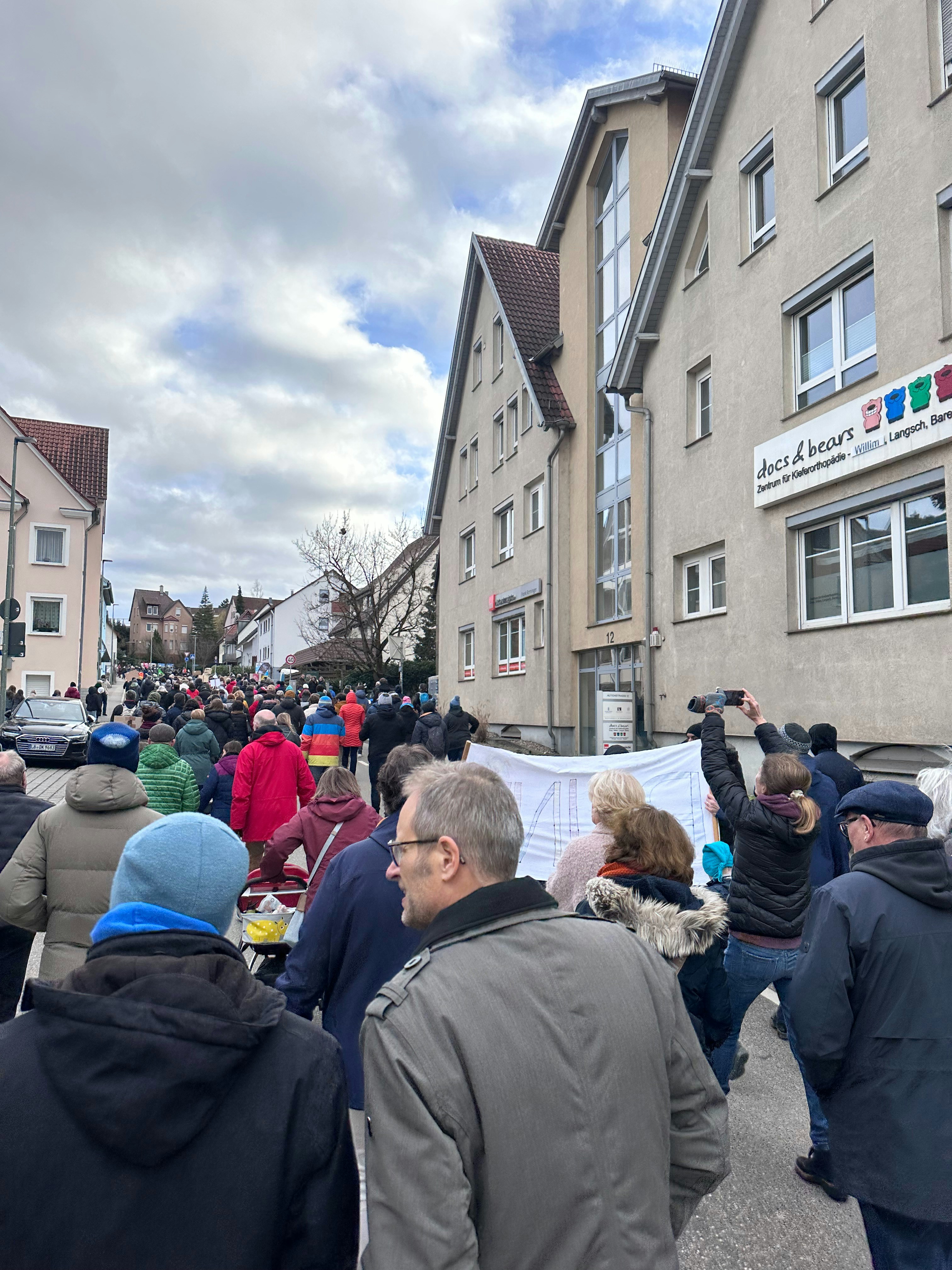 a crowd of people standing in front of a building