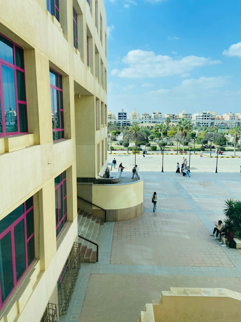 a group of people walking around a courtyard next to a building