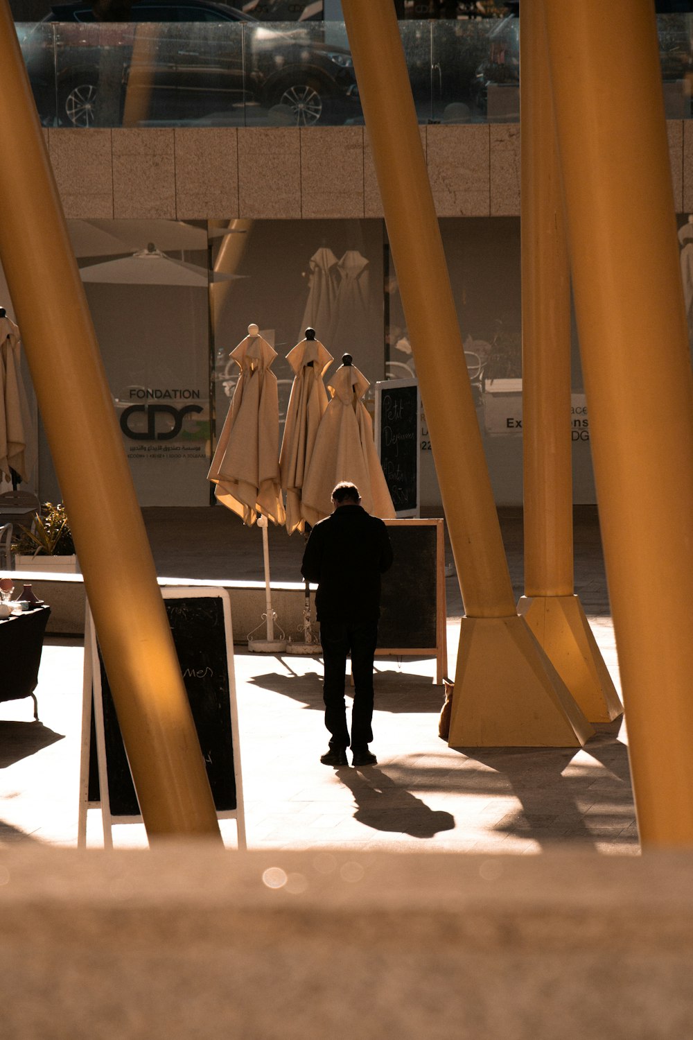 a man standing in front of a display of umbrellas