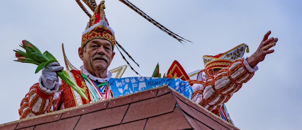 a man in a costume standing on top of a roof