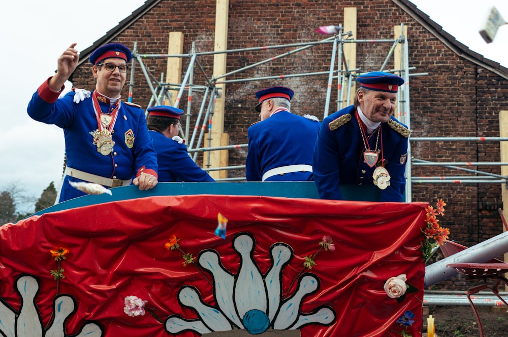 a group of men riding on the back of a float