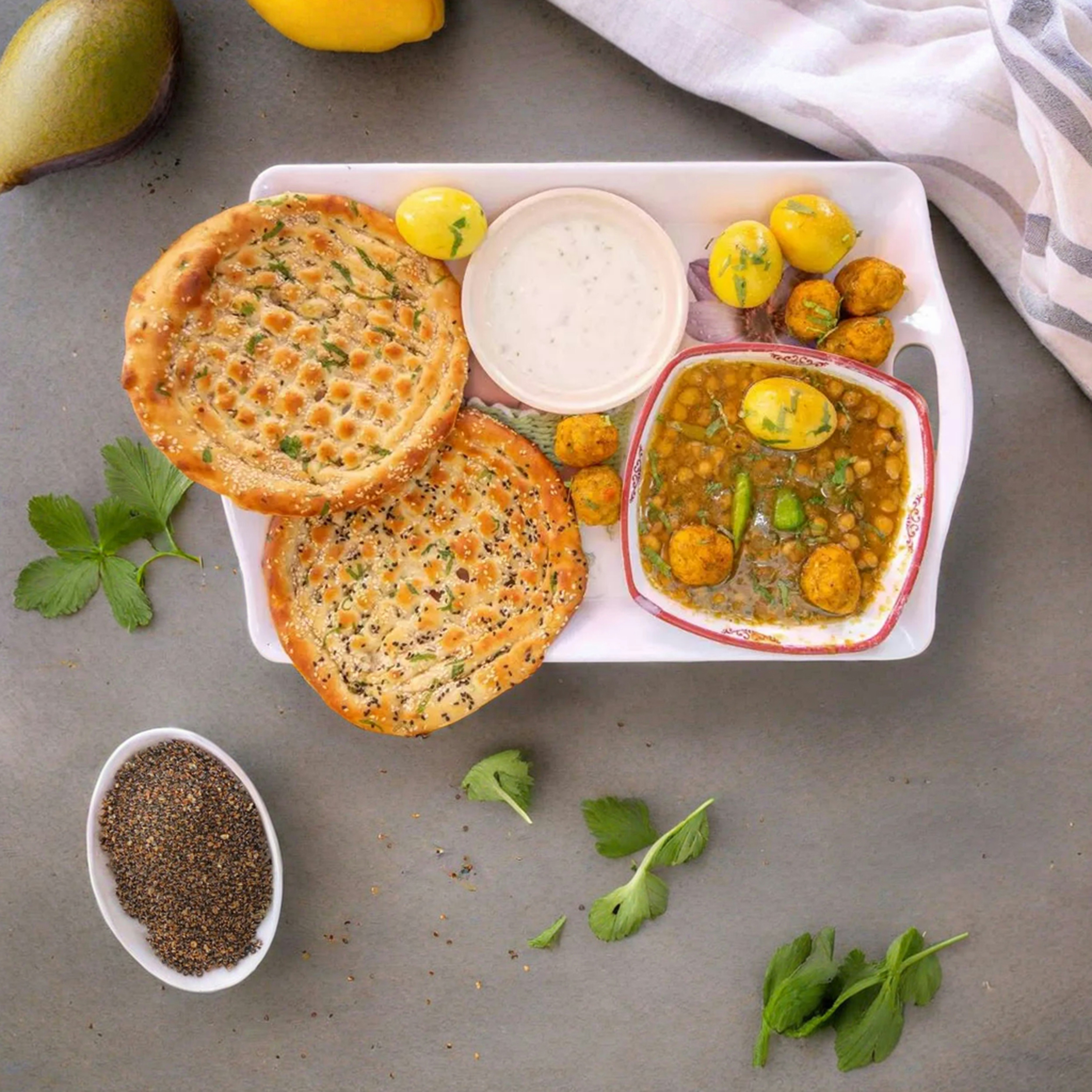 a plate of food on a table next to a bowl of soup