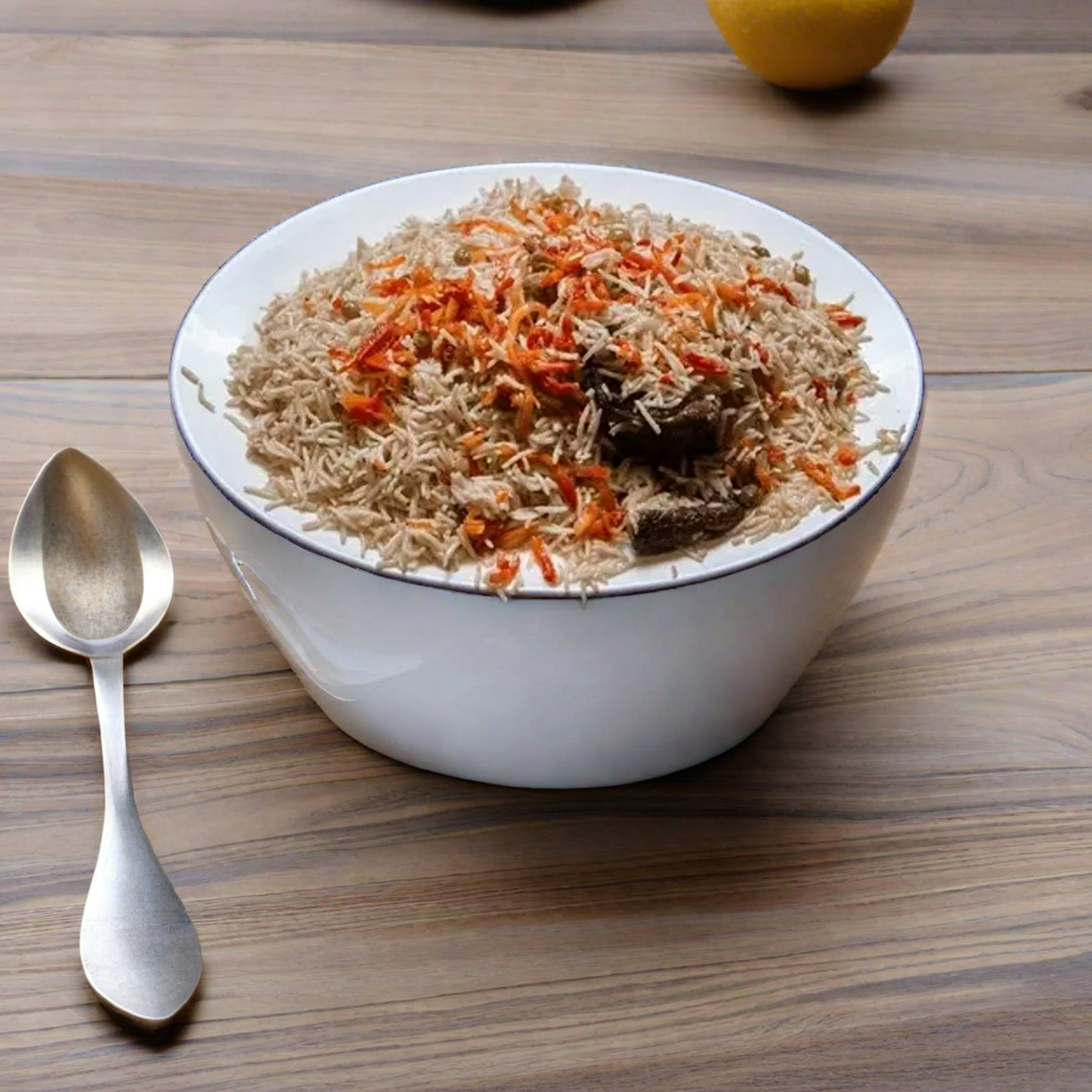 a bowl of food with a spoon next to it