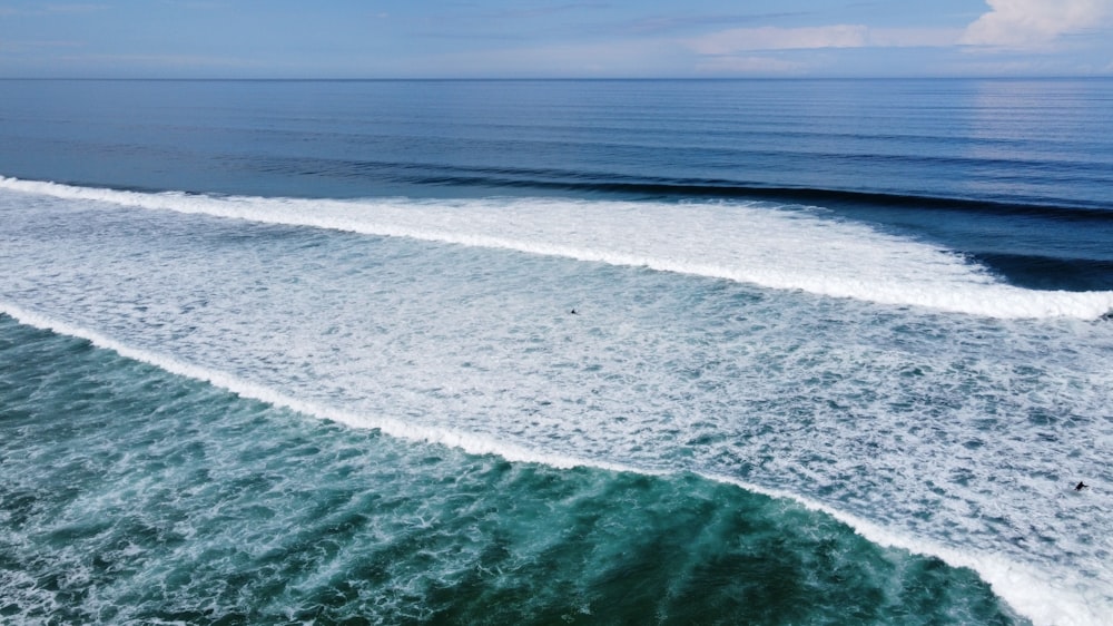 a large body of water with a wave coming in