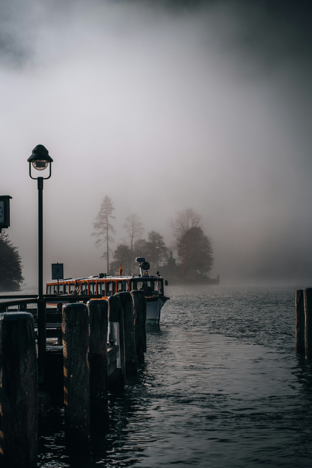 a dock on a lake with a light on it