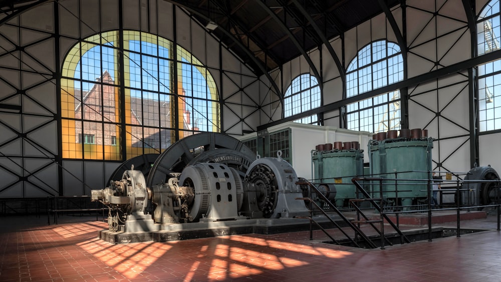 a large machine in a large building with big windows