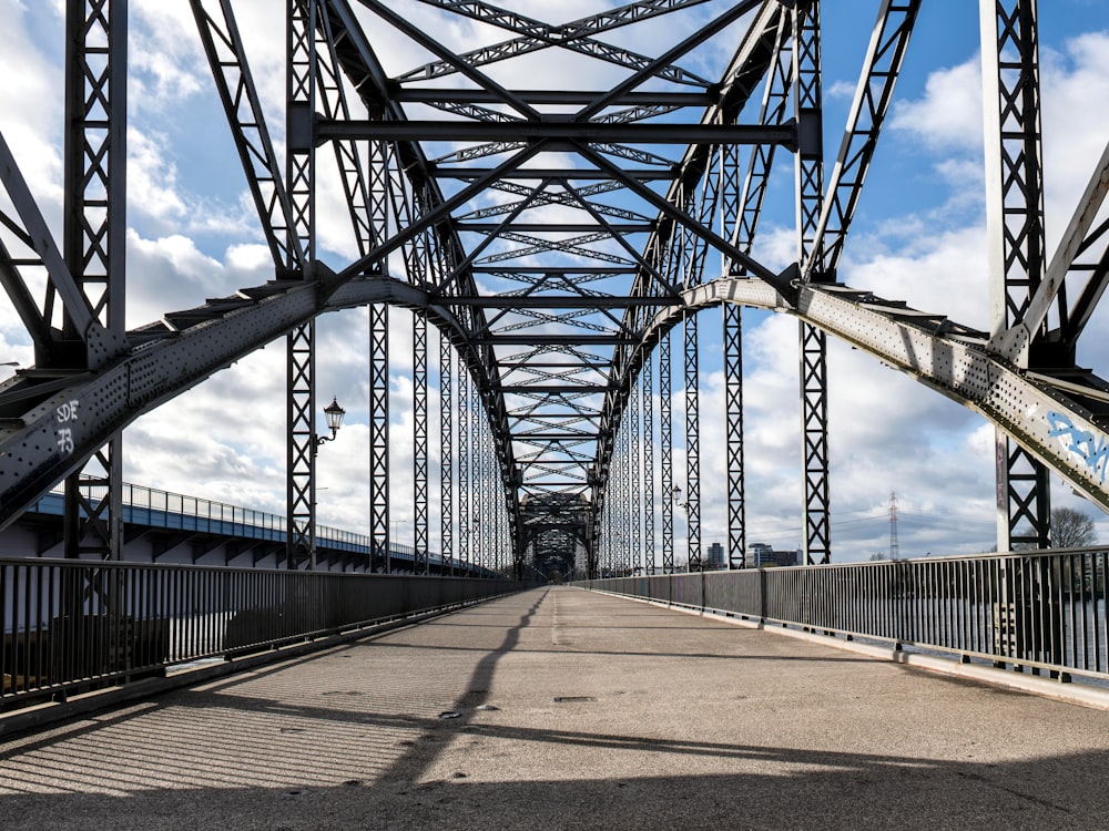 a large metal bridge spanning over a river