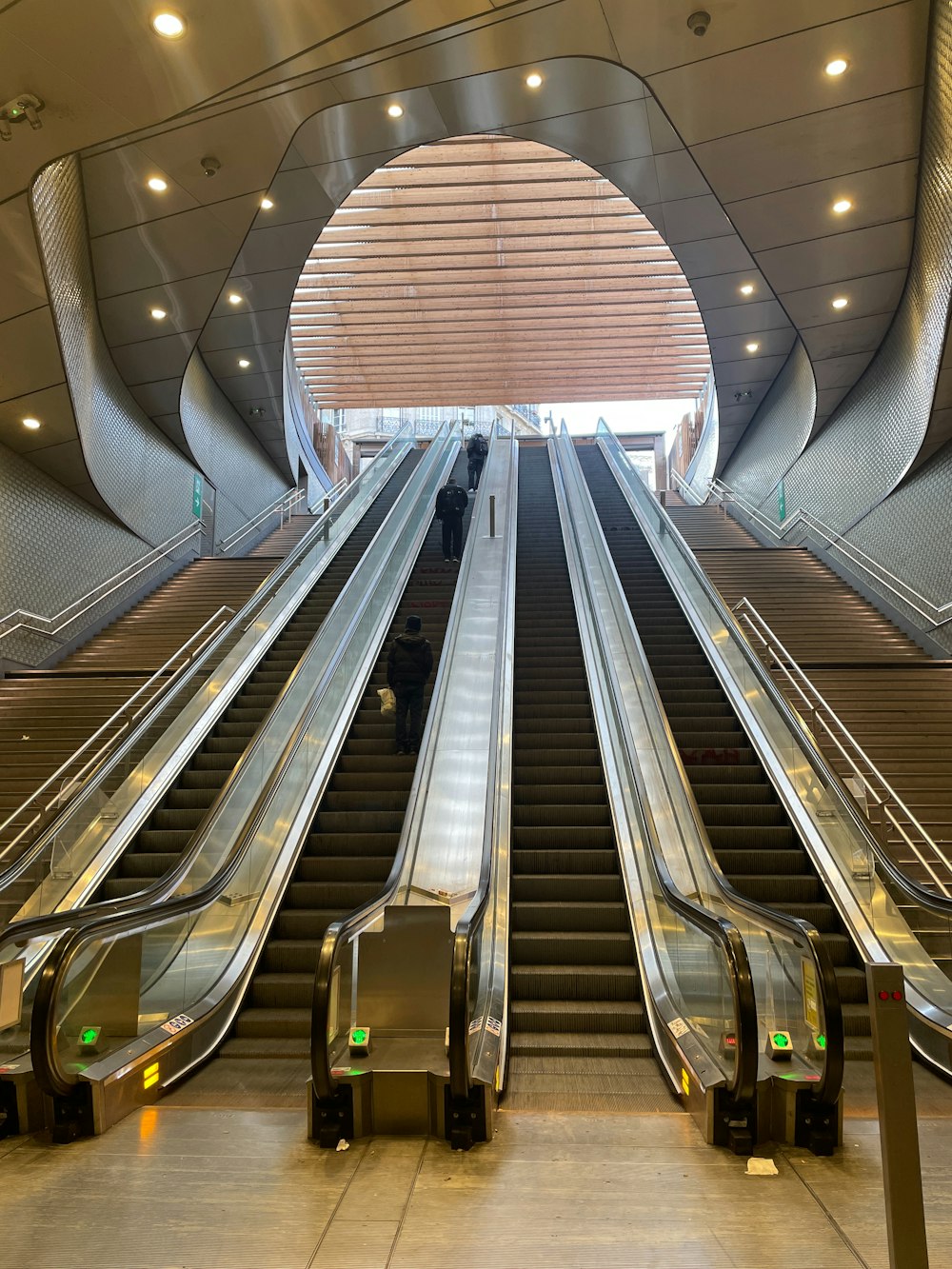 a group of escalators going up and down in a building