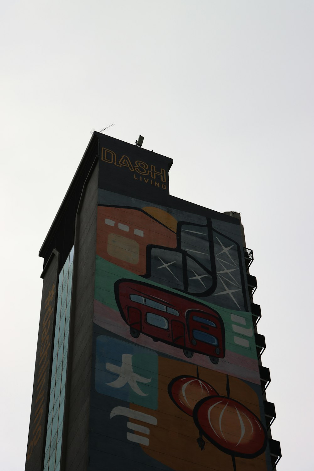 a tall building with a mural on the side of it