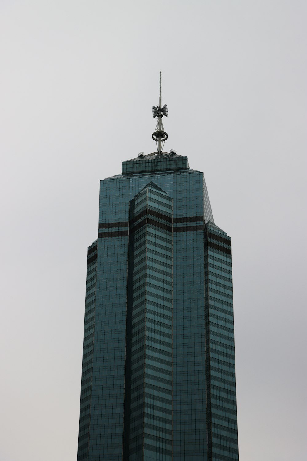 a tall building with a weather vane on top of it