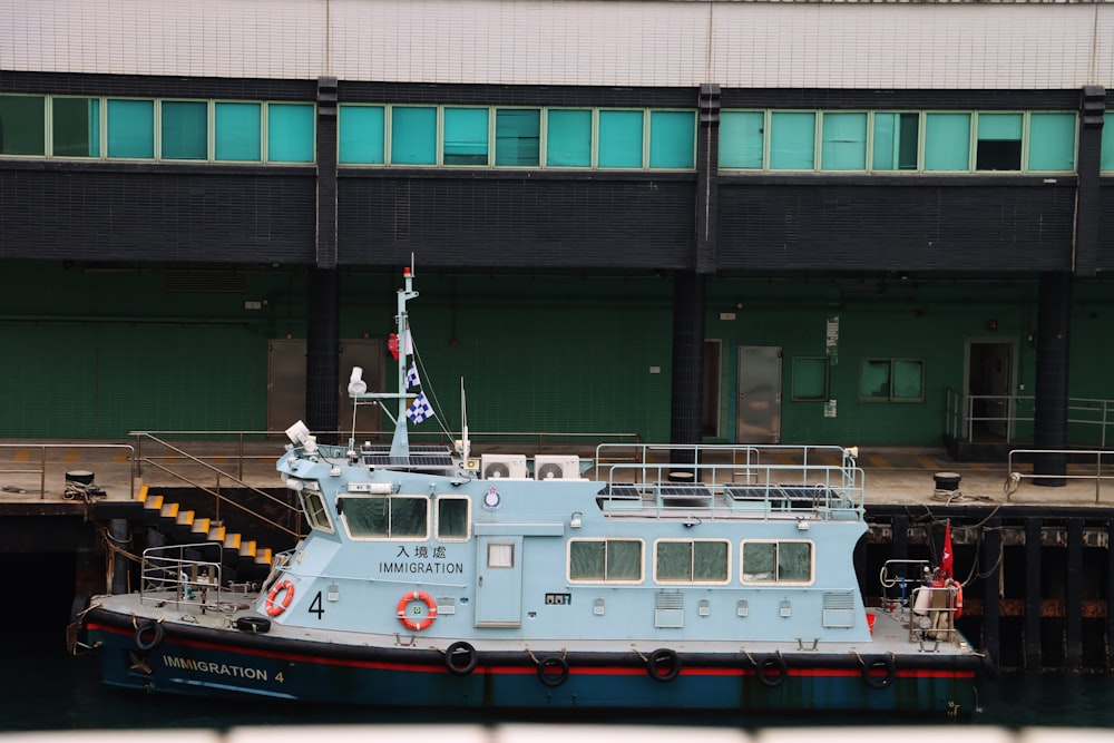 a large blue boat docked in a harbor