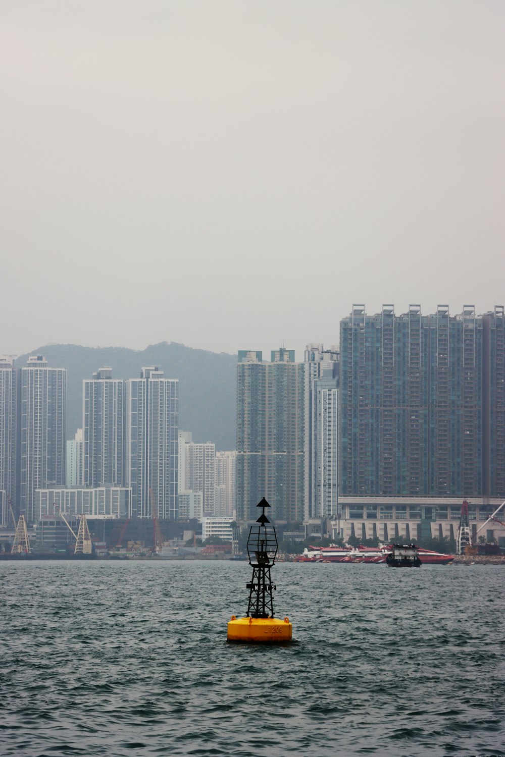 a yellow buoy floating in the middle of a body of water