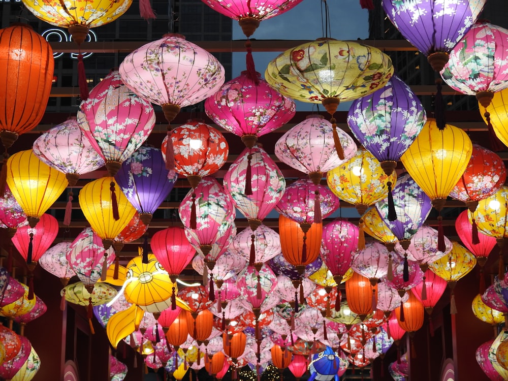 a room filled with lots of colorful paper lanterns