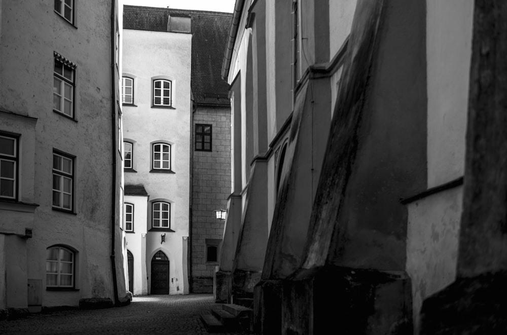 a black and white photo of a narrow street