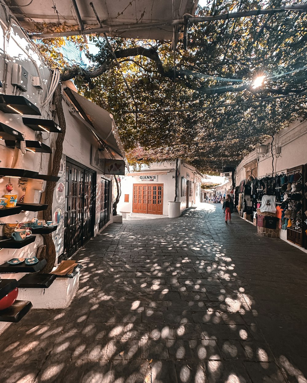 a street with a bunch of shoes hanging from the ceiling