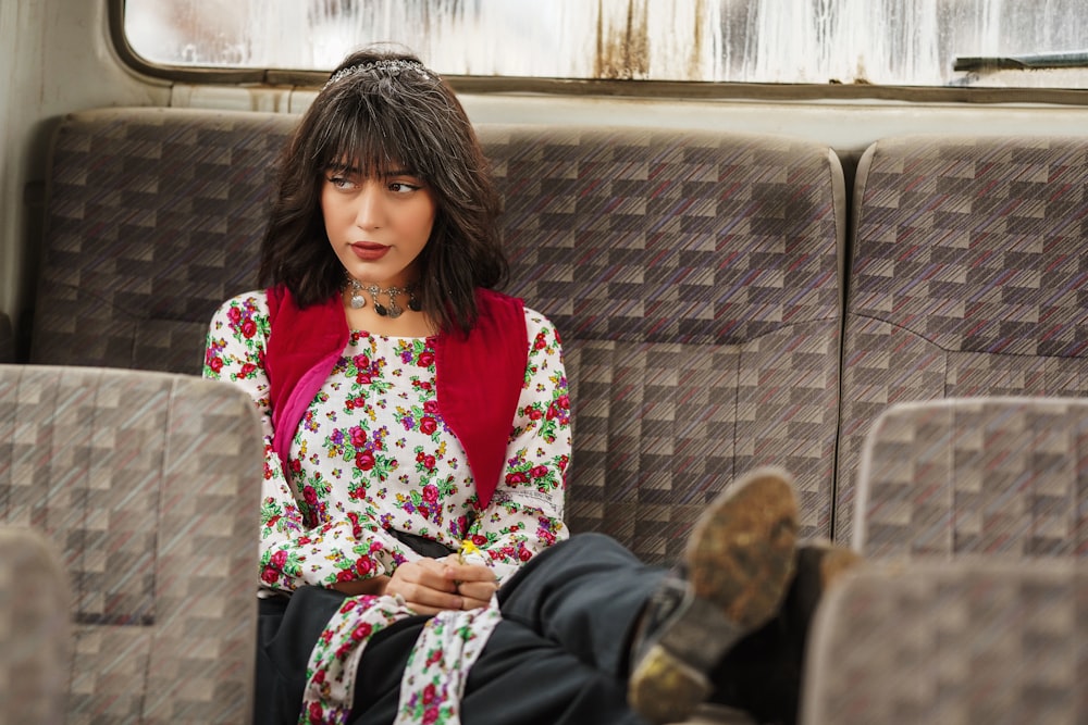 a woman sitting on a bus with her legs crossed