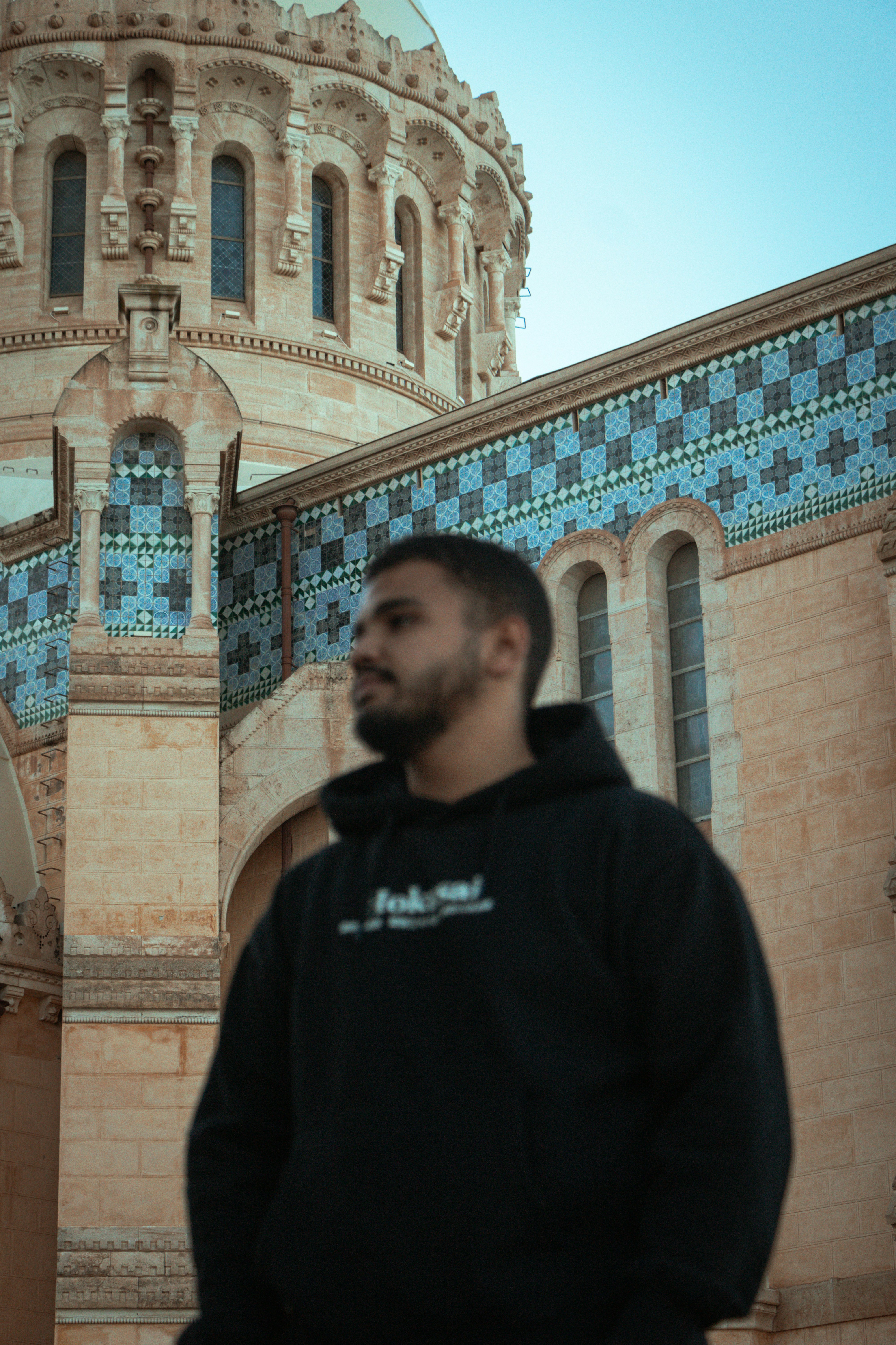 A man is standing in front of a building photo – Free Art Image on Unsplash
