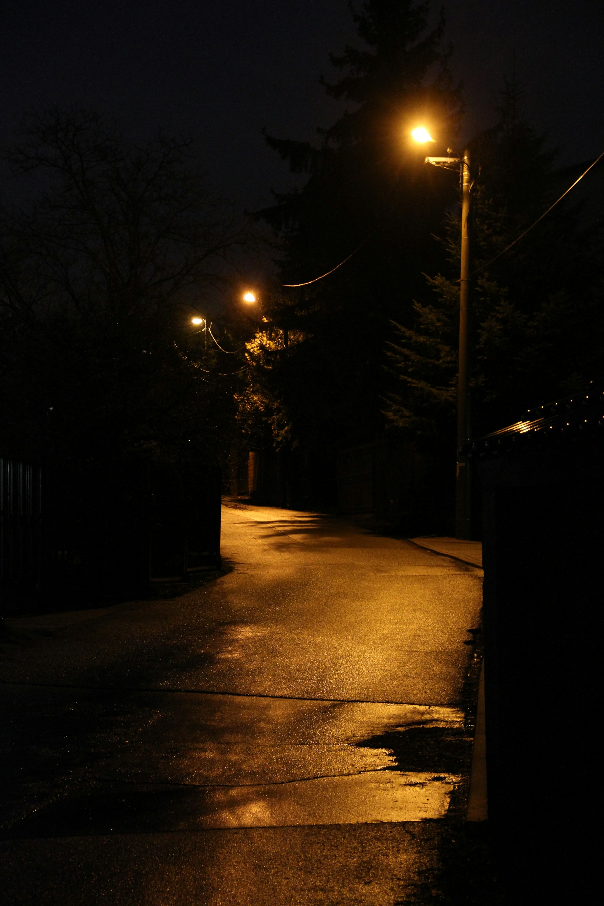 a dark street at night with street lights