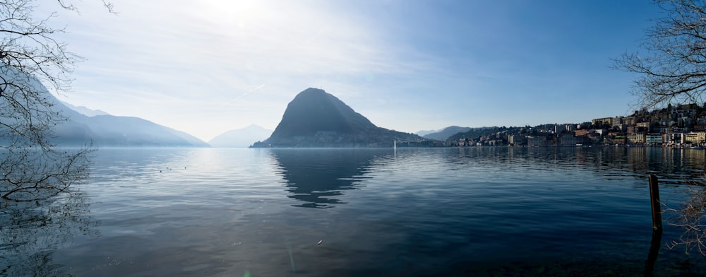 a body of water with a mountain in the background