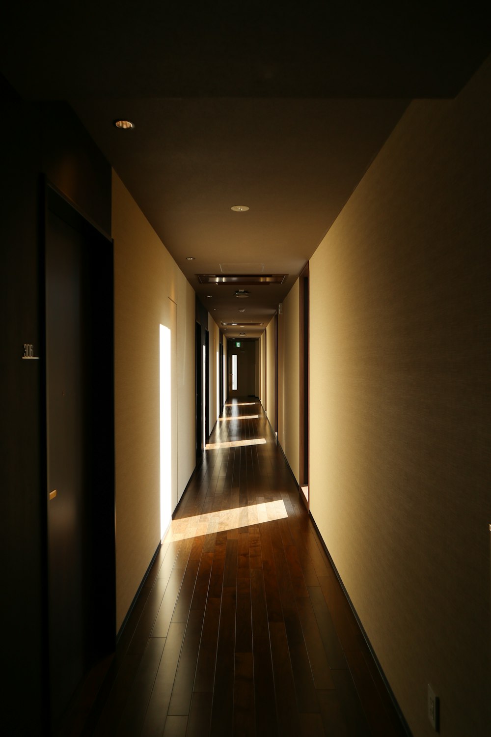 a long hallway with light coming through the windows