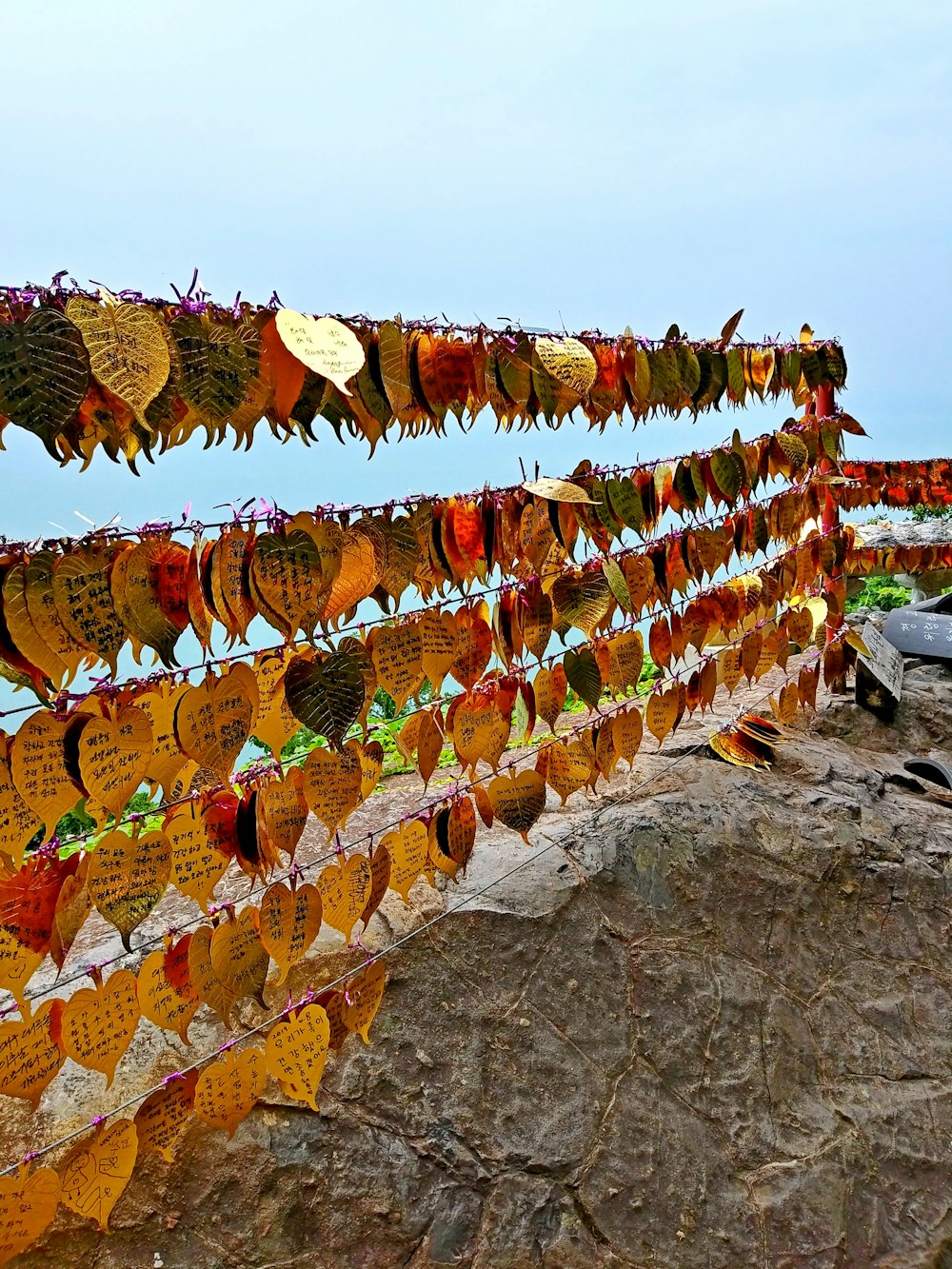 a stone wall with a bunch of signs on it