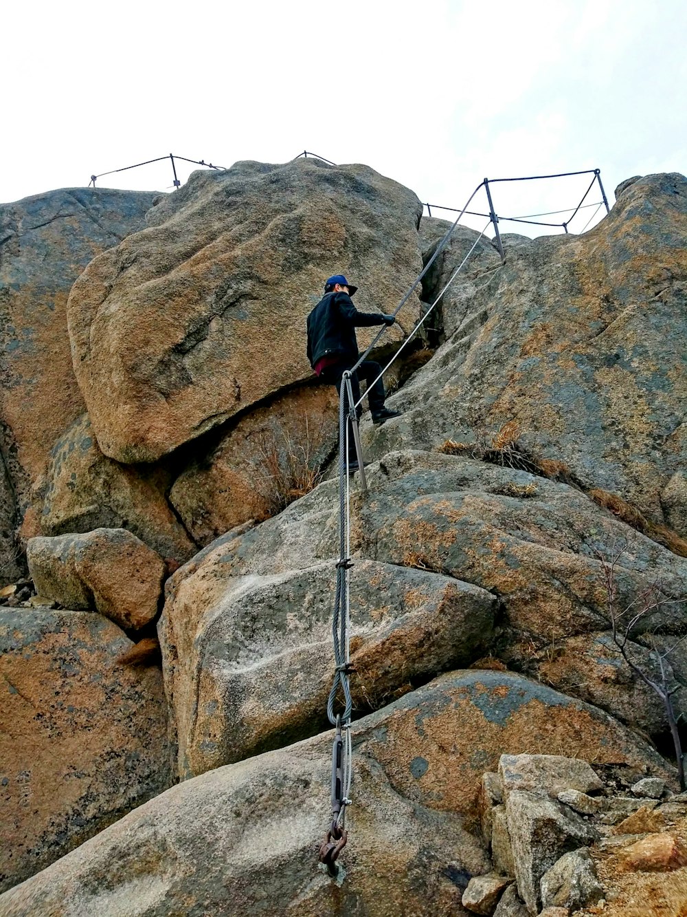 a man climbing up the side of a mountain