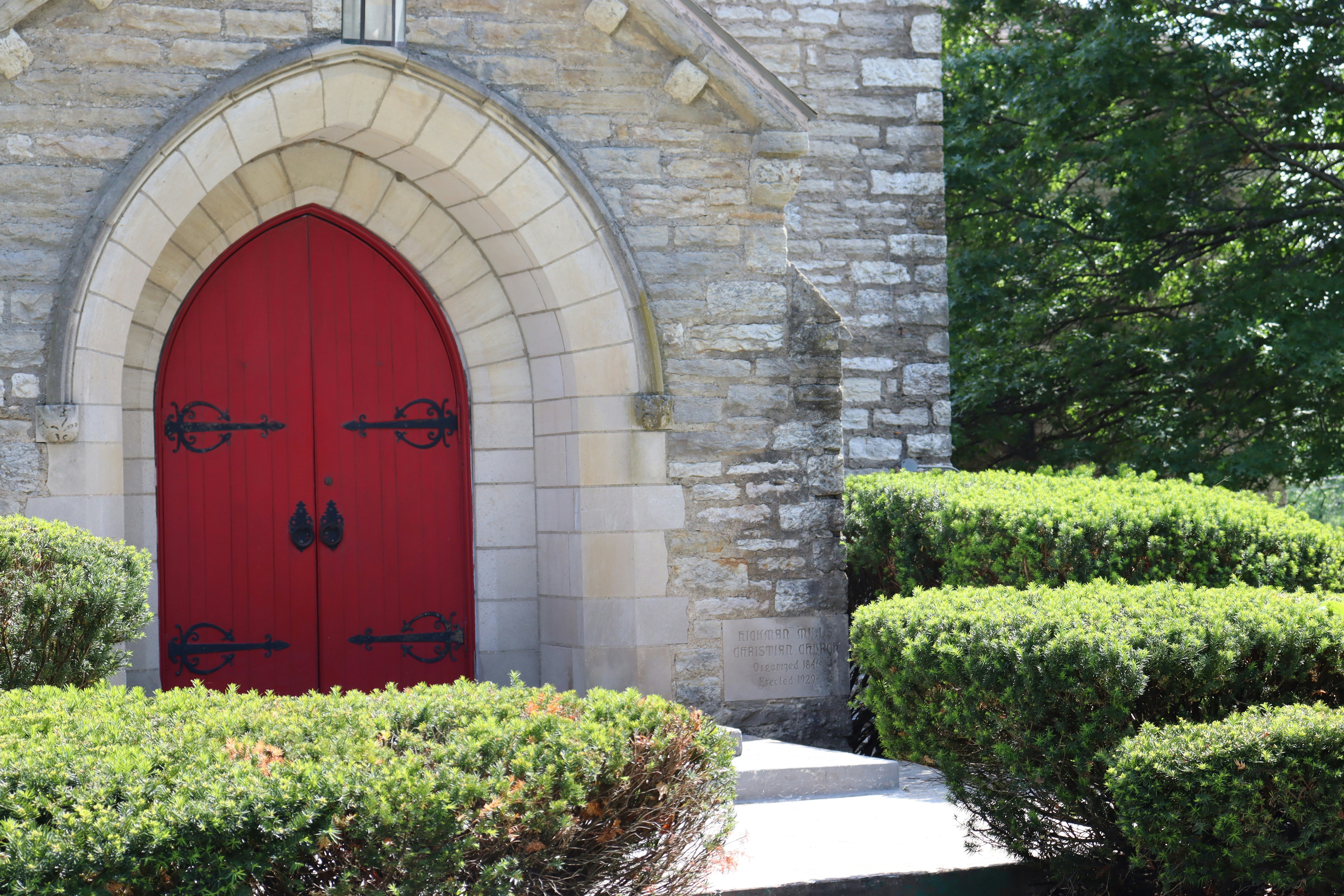 A red door in front of a stone building photo – Free South kansas city ...