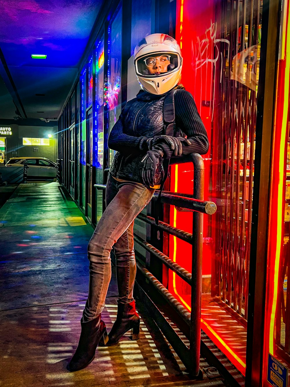 a woman in a helmet leaning on a rail