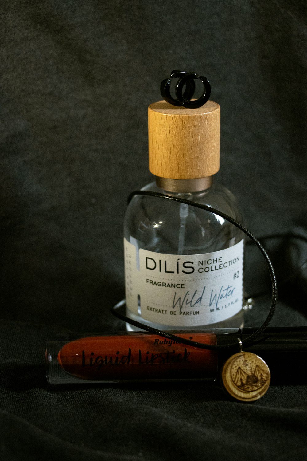 a bottle of alcohol and a baseball bat on a black background
