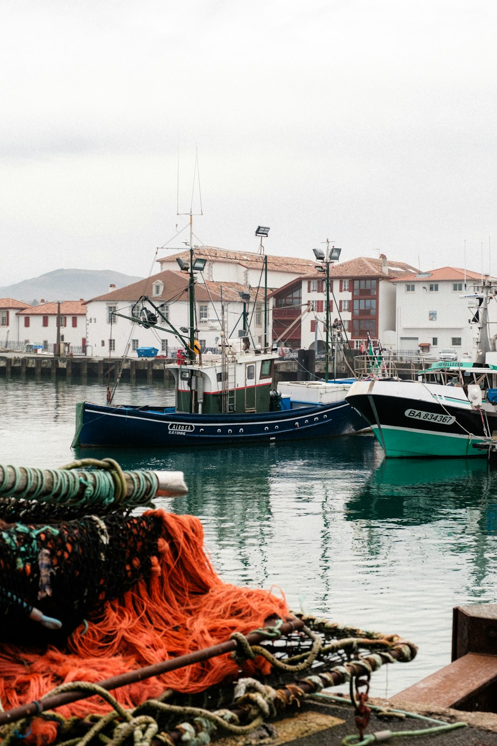 a harbor filled with lots of boats on top of water