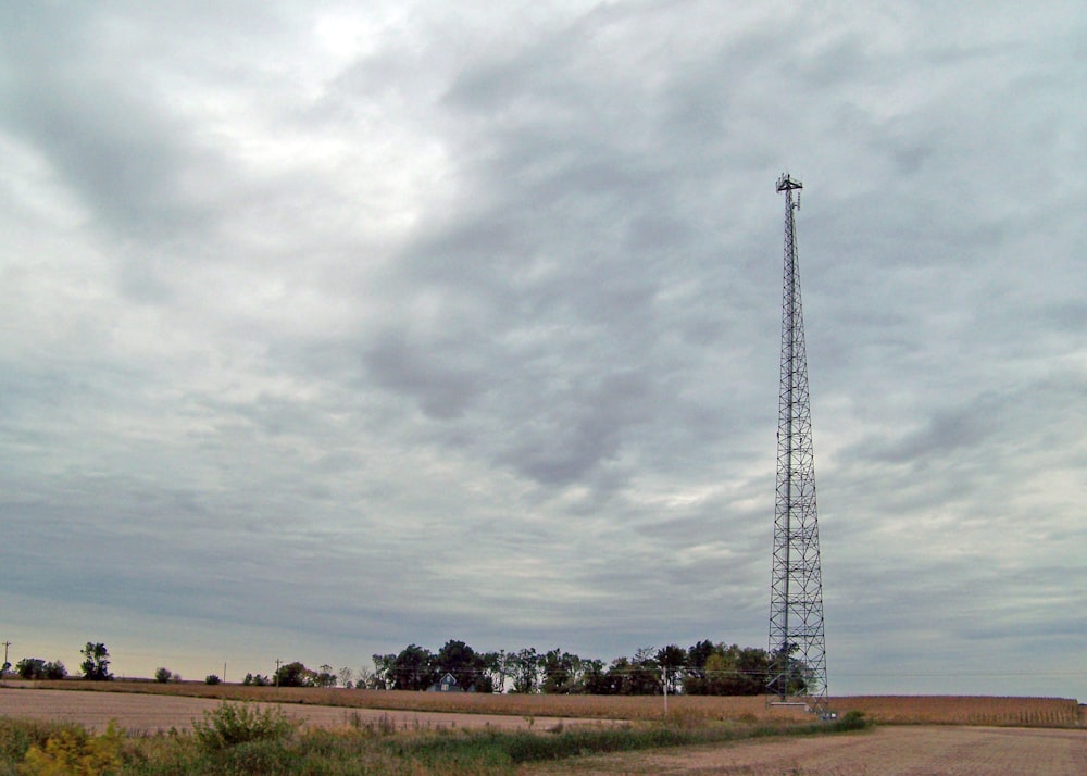 a field with a tower in the middle of it