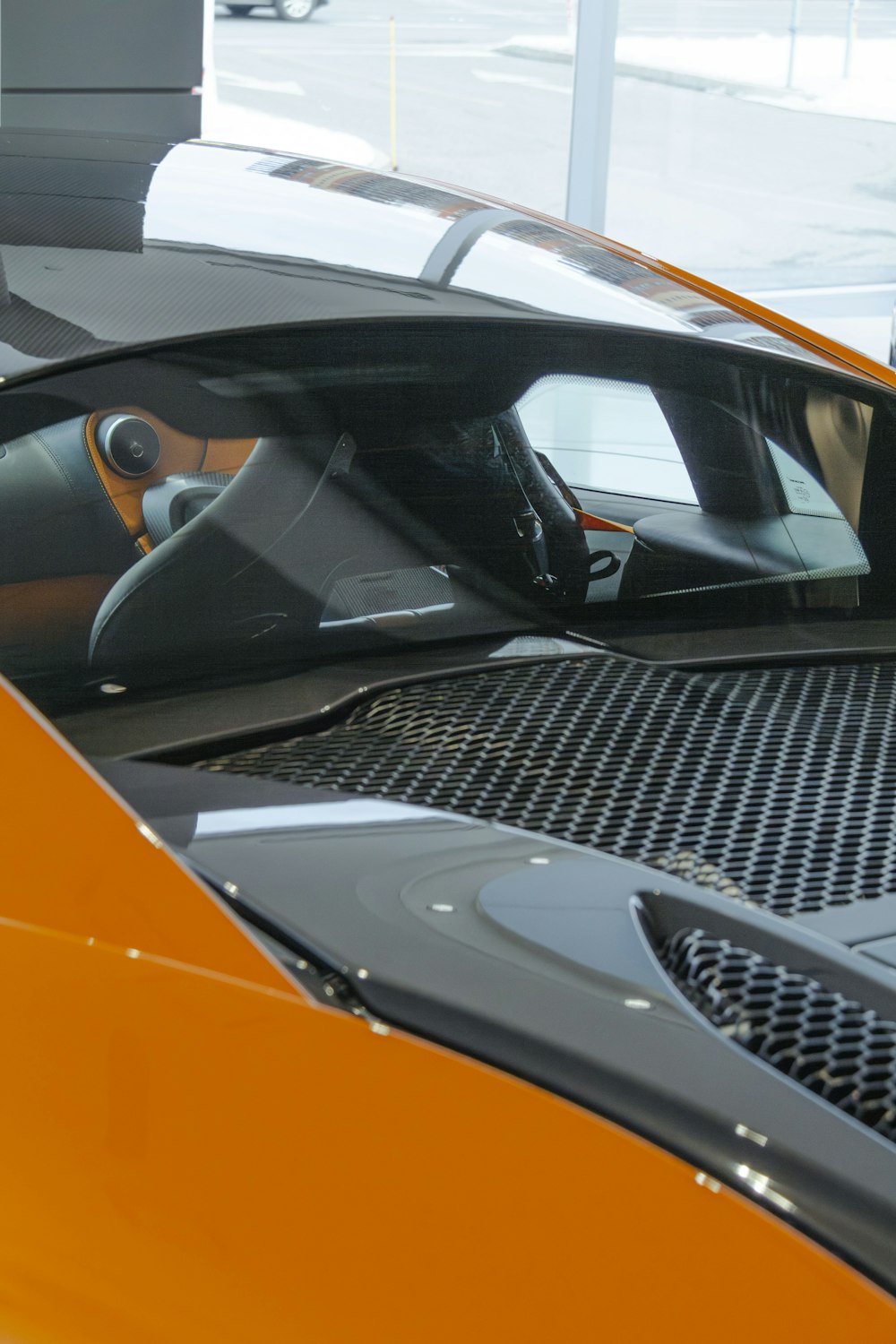 an orange sports car parked in a garage