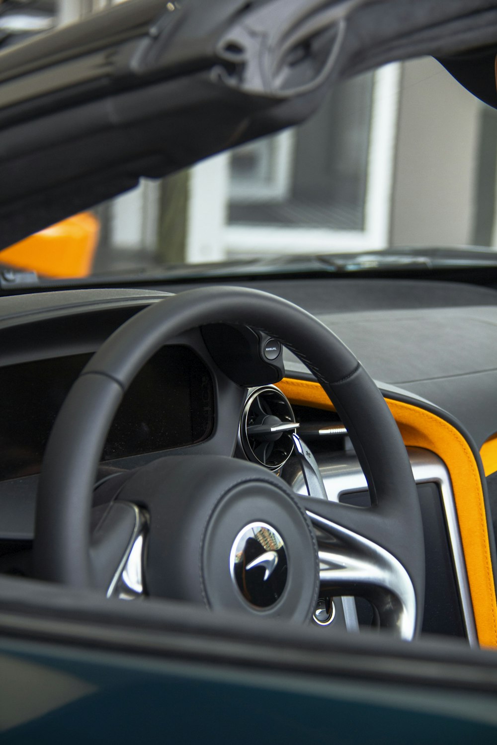 a close up of a car steering wheel and dashboard