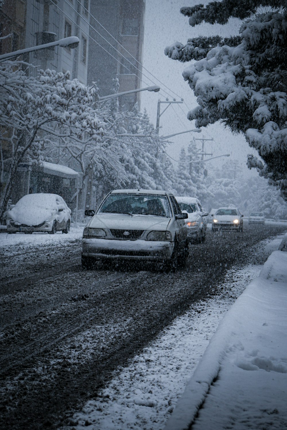 a car driving down a snow covered street