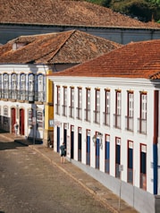 a white building with red and blue shutters