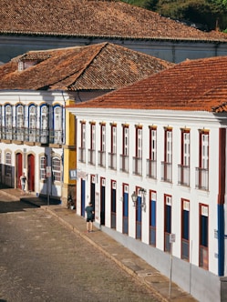 a white building with red and blue shutters