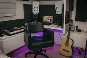 a recording studio with a keyboard and a guitar