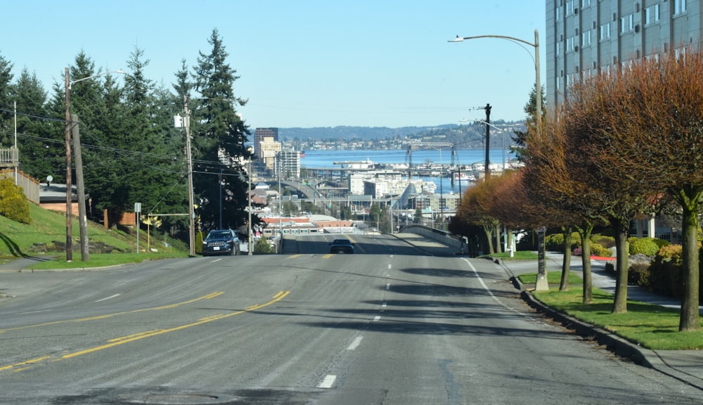 a car driving down a street next to tall buildings