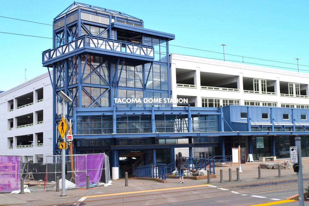 a blue and white building sitting on the side of a road