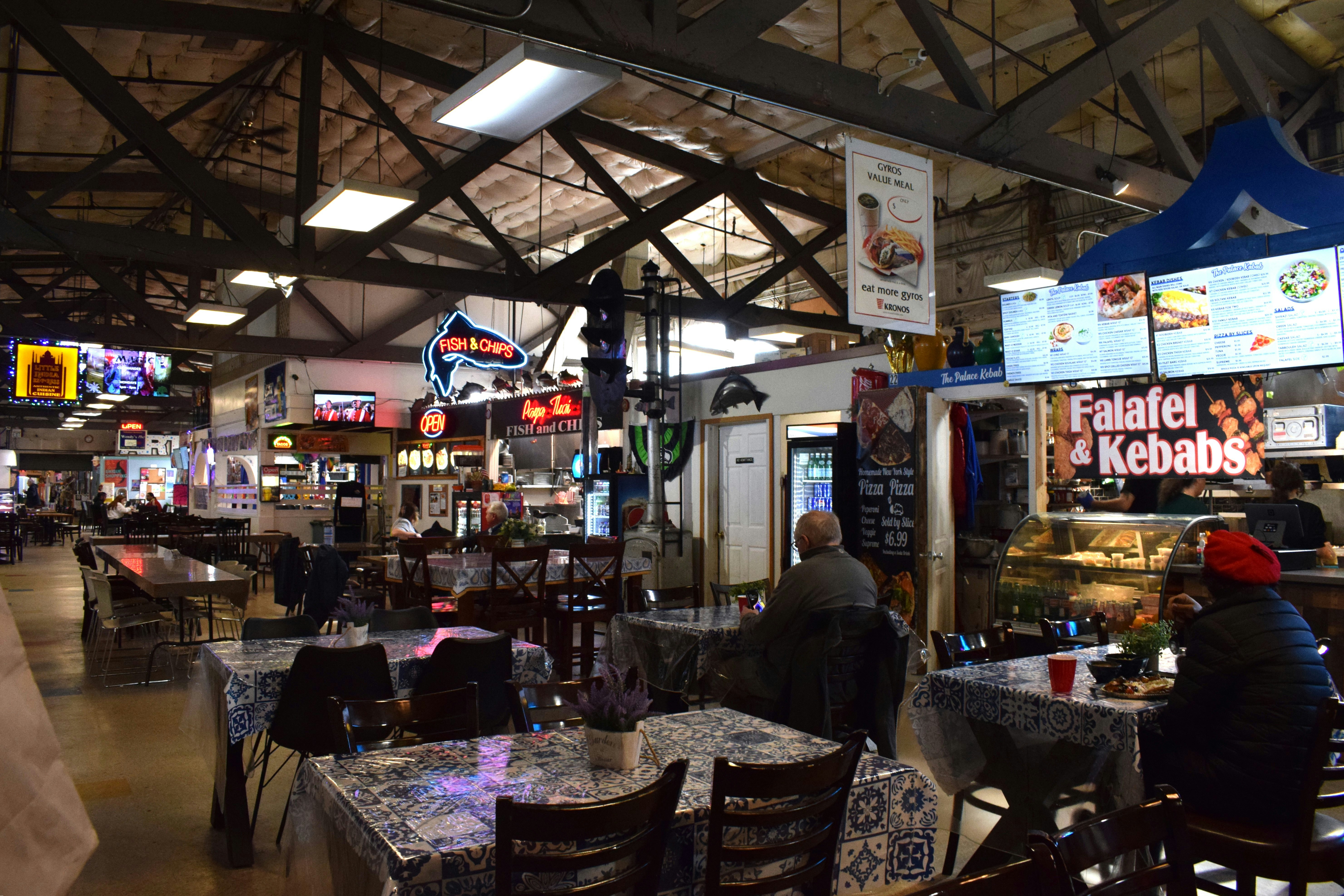 a group of people sitting at tables in a restaurant