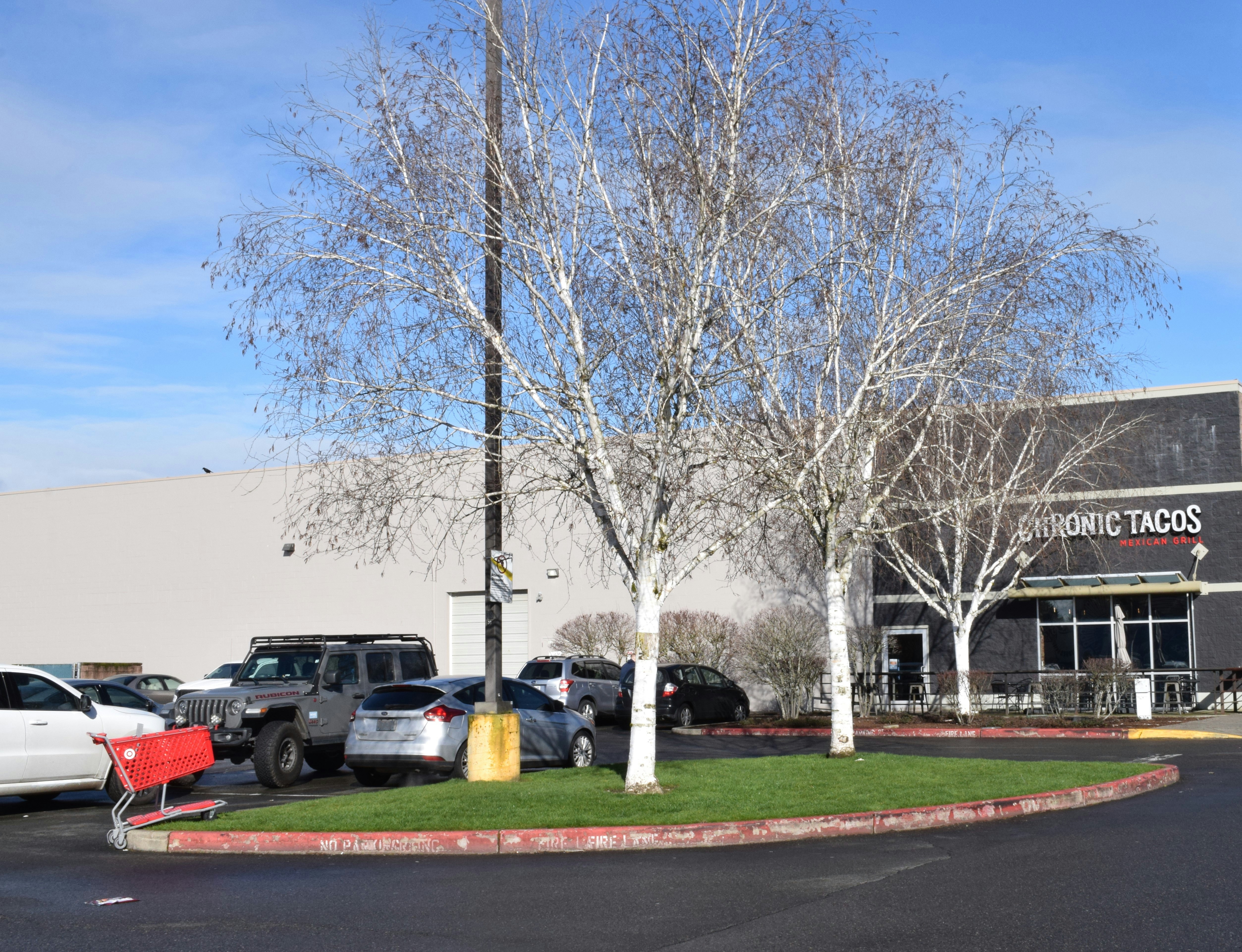 a parking lot with cars parked in front of a building
