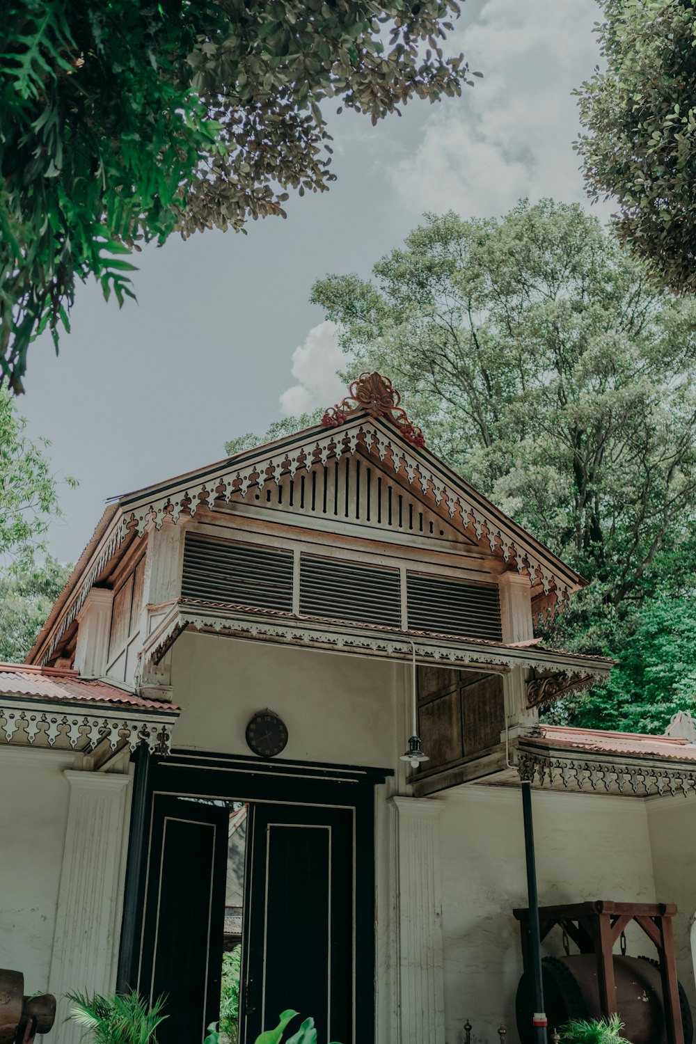 a building with a wooden roof and a black door