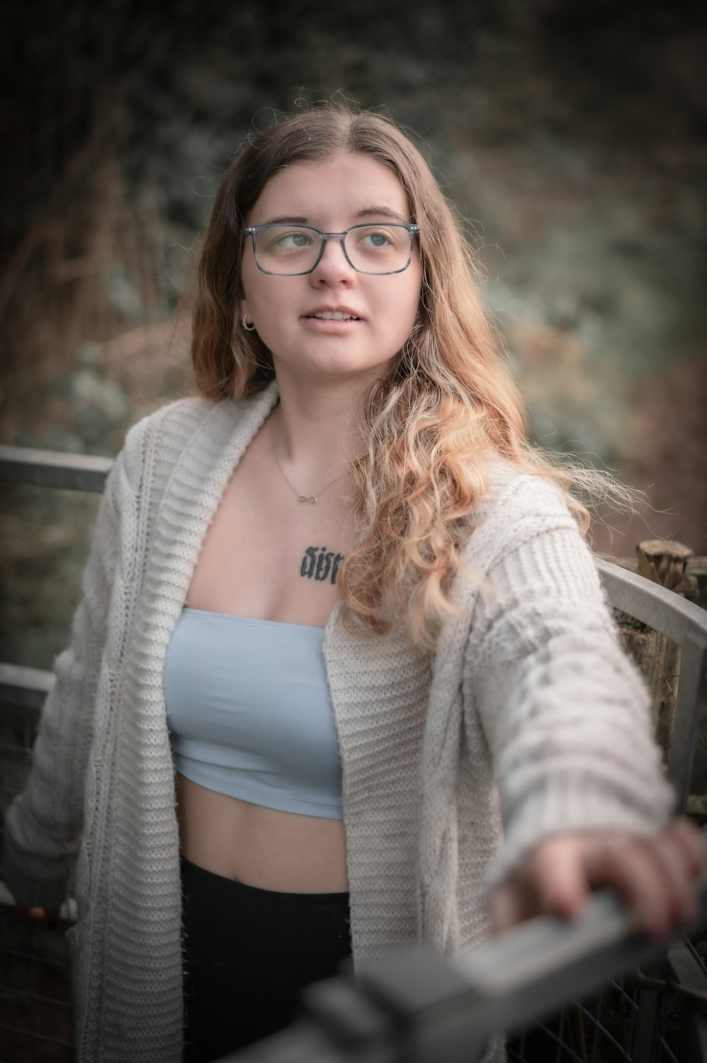 a woman wearing glasses and a crop top