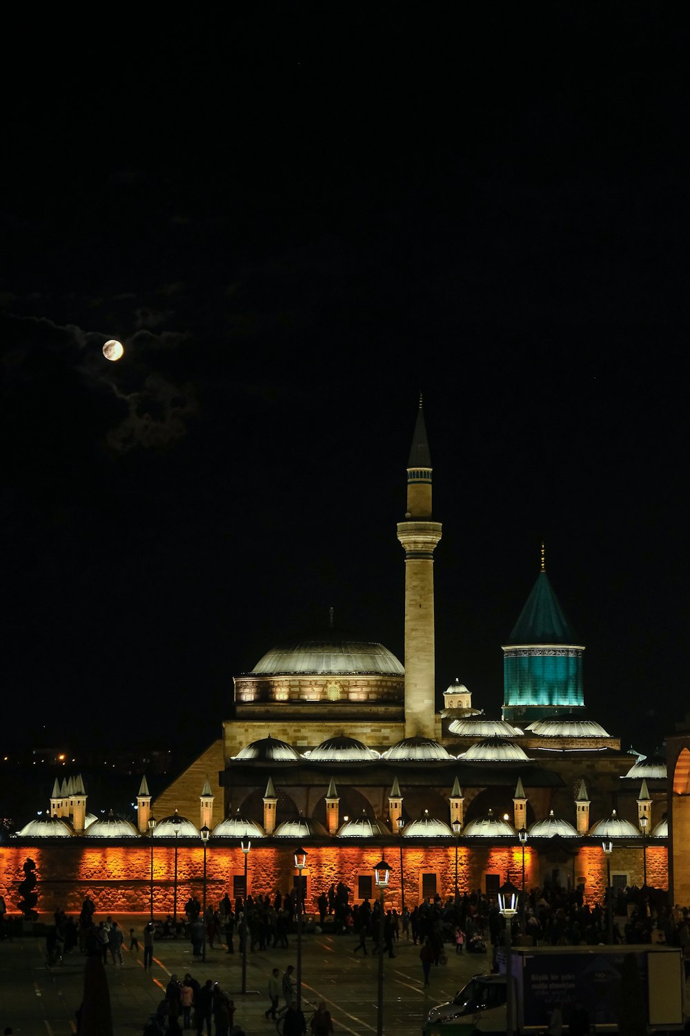 a large building with a clock tower at night