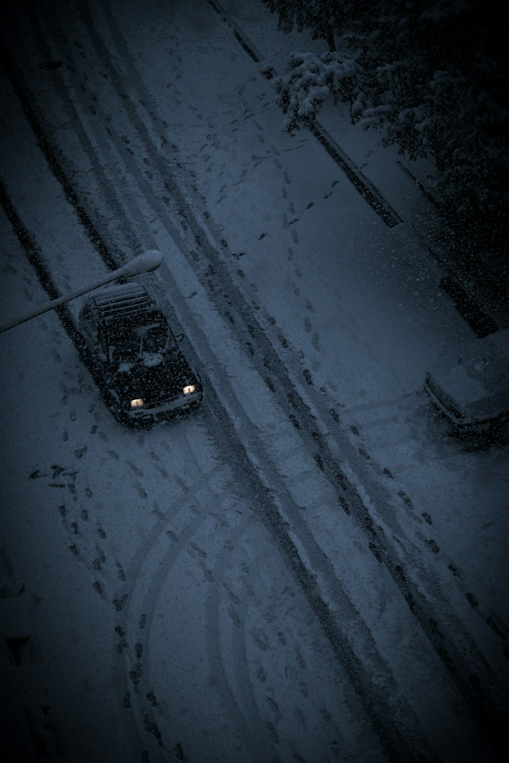 a car driving down a snow covered road