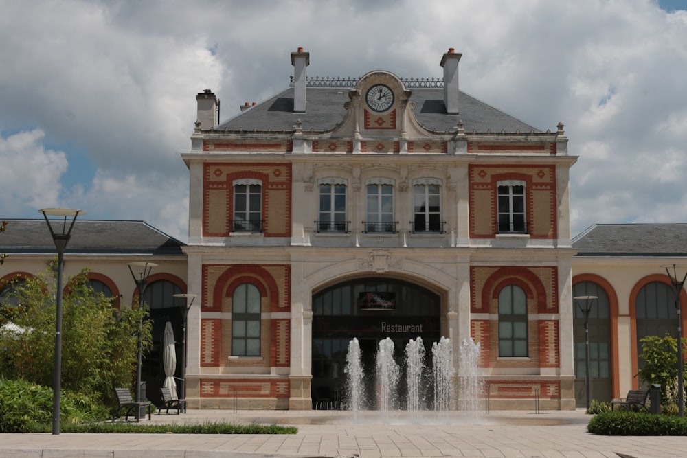 a large building with a fountain in front of it