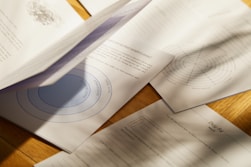 a close up of papers on a wooden table