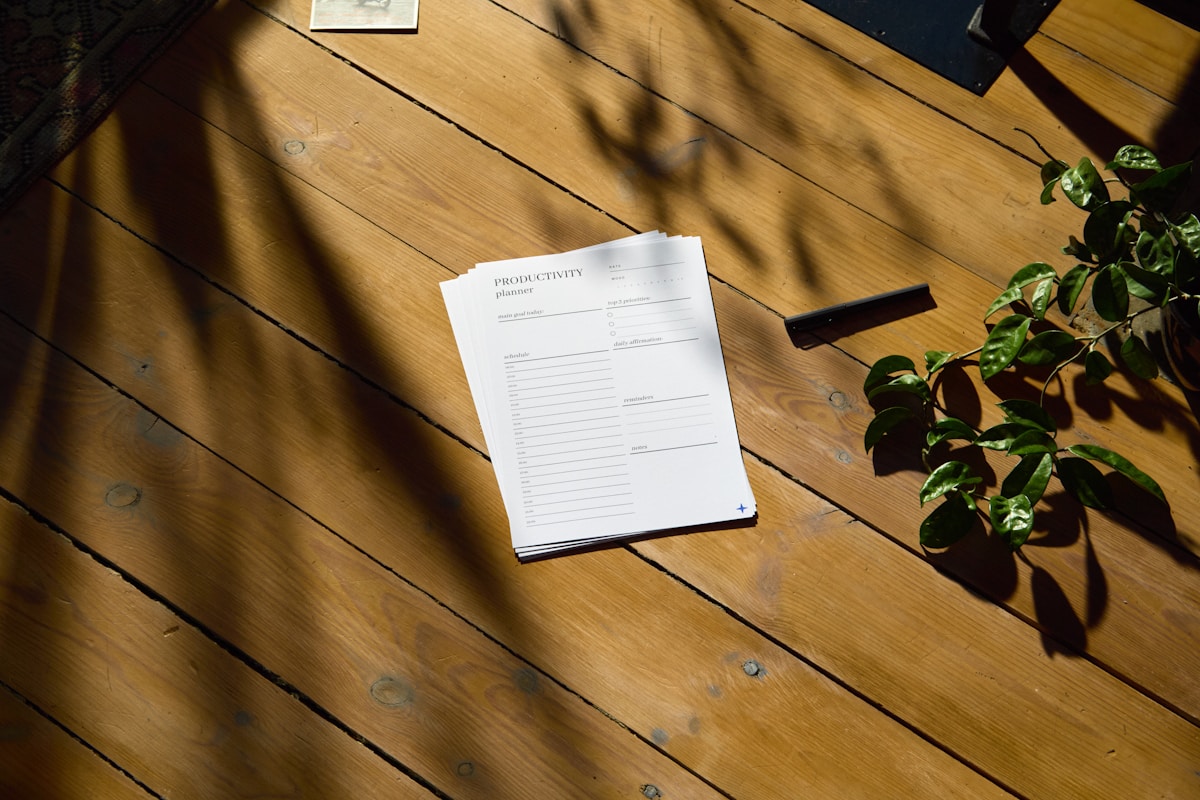 A field trip planning checklist on a wooden table, detailing logistics and chaperone sign-up information.