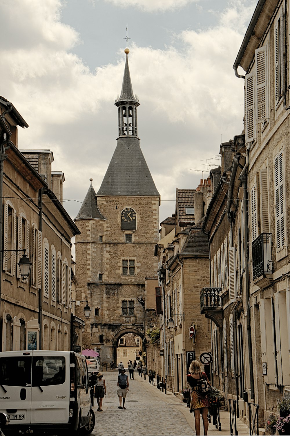 people walking down a street in a european city