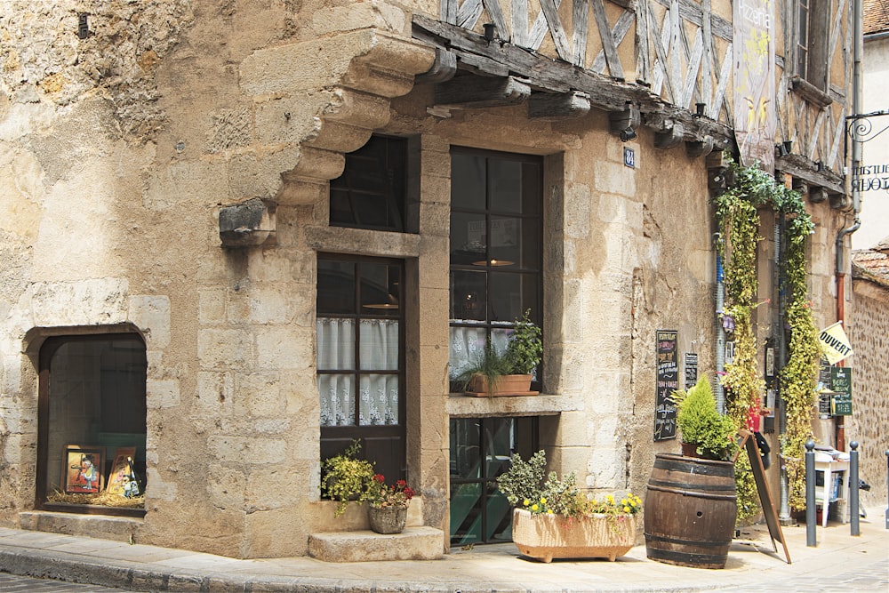 a stone building with potted plants outside of it